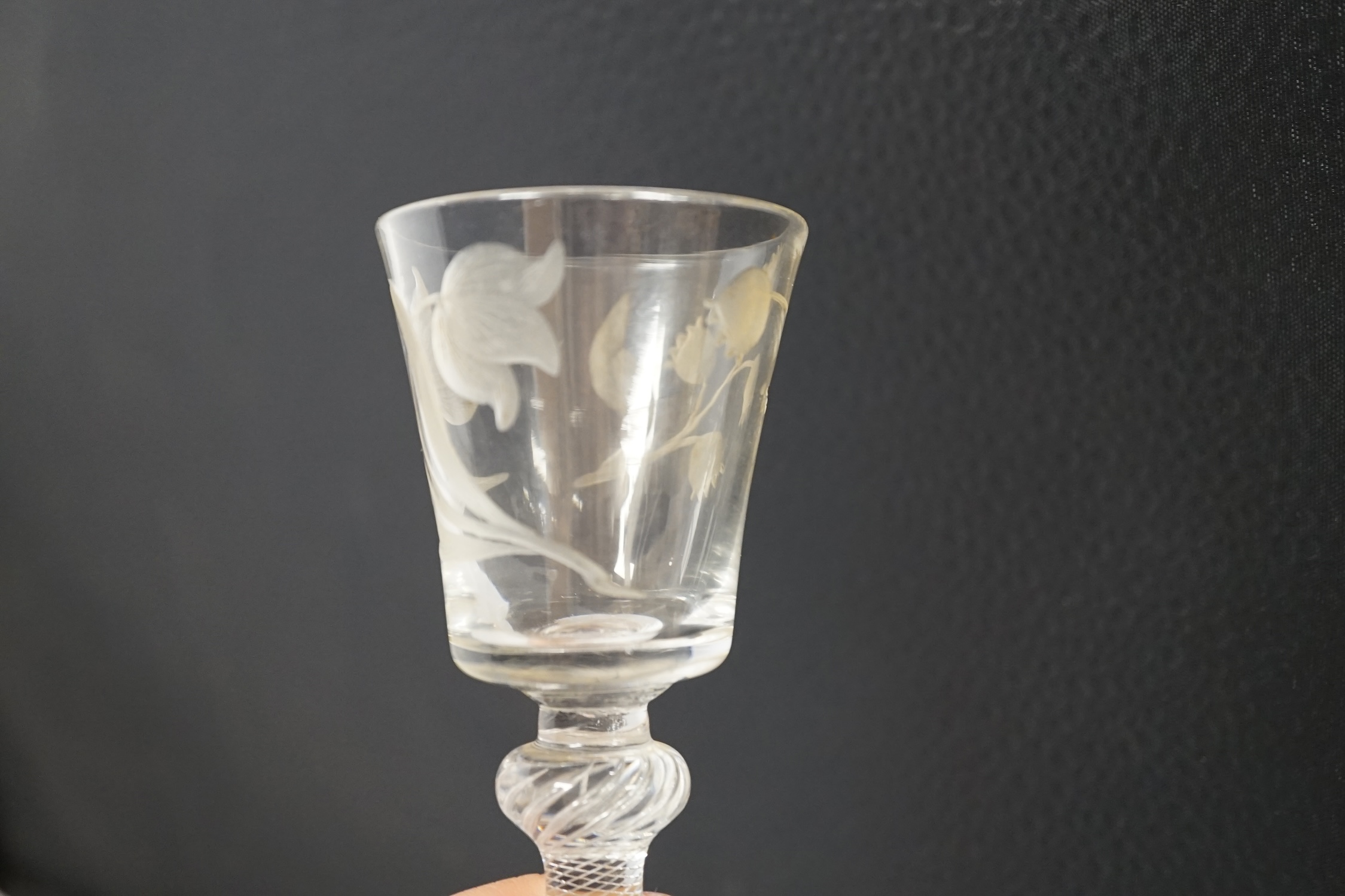 A mid 18th century air twist stem cordial glass with later engraved decoration, 15.5cm high. Condition - fair